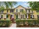 Charming yellow townhome featuring a welcoming front porch and lush green landscaping at 1123 Market St, Fort Mill, SC 29708