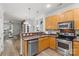 Bright kitchen featuring stainless steel appliances, wood cabinets, and an open layout at 1123 Market St, Fort Mill, SC 29708