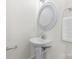 Simple powder room with a white pedestal sink, mirror, and towel rack at 1123 Market St, Fort Mill, SC 29708