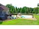 Backyard featuring pool, lounge area, and a spacious lawn perfect for outdoor enjoyment at 141 Weathers Creek Rd, Troutman, NC 28166