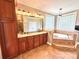 Primary bathroom features a double vanity, soaking tub, and natural light at 141 Weathers Creek Rd, Troutman, NC 28166