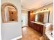Lovely bathroom with a dual sink vanity, arched shower, and outside access at 141 Weathers Creek Rd, Troutman, NC 28166