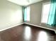Relaxing bedroom featuring hardwood floors, window views, and calming neutral walls at 141 Weathers Creek Rd, Troutman, NC 28166