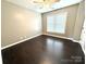Bright bedroom showcasing dark hardwood floors, a ceiling fan and natural lighting at 141 Weathers Creek Rd, Troutman, NC 28166