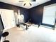 Bedroom features navy walls, a ceiling fan, workout equipment and bright natural lighting at 141 Weathers Creek Rd, Troutman, NC 28166