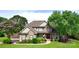 Charming two-story home featuring brick accents, a manicured lawn, mature trees, and a welcoming front porch at 141 Weathers Creek Rd, Troutman, NC 28166