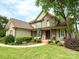 Traditional home with a well-kept lawn, mature landscaping, and a cozy front porch with seating at 141 Weathers Creek Rd, Troutman, NC 28166