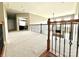 Open loft with neutral carpet and a view into the living room at 141 Weathers Creek Rd, Troutman, NC 28166