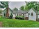 Admire a well-maintained backyard with lush green lawn, mature trees, and classic home exteriors at 14831 Charterhouse Ln, Huntersville, NC 28078