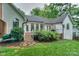 Delight in the beautifully landscaped backyard featuring a patio, lush greenery, and classic white exteriors at 14831 Charterhouse Ln, Huntersville, NC 28078