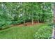 A sprawling backyard showcases mature trees and provides a private, shaded oasis at 14831 Charterhouse Ln, Huntersville, NC 28078