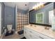 This blue bathroom features a double sink vanity with a large mirror and a shower and tub combo at 14831 Charterhouse Ln, Huntersville, NC 28078