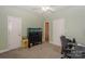 Bedroom with neutral carpets has a fish tank, a ceiling fan, and two closets at 14831 Charterhouse Ln, Huntersville, NC 28078