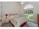 A well-lit bedroom features a queen-sized bed, bedside table and a large arched window at 14831 Charterhouse Ln, Huntersville, NC 28078
