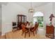 Bright dining room with hardwood floors, china cabinet and elegant lighting at 14831 Charterhouse Ln, Huntersville, NC 28078