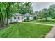 Well-maintained single-story home with lush green lawn and mature trees at 14831 Charterhouse Ln, Huntersville, NC 28078