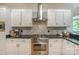 Close-up of the kitchen with stainless steel range and oven and gray tile backsplash at 14831 Charterhouse Ln, Huntersville, NC 28078