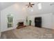 Spacious living room with vaulted ceilings, fireplace, and large windows at 14831 Charterhouse Ln, Huntersville, NC 28078