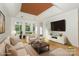 Bright living room with coffered ceilings, hardwood floors and large windows at 14831 Charterhouse Ln, Huntersville, NC 28078