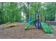 Community playground with colorful play structures nestled among mature trees at 14831 Charterhouse Ln, Huntersville, NC 28078
