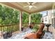 Relaxing covered back porch has cozy seating with views of the private wooded backyard at 15416 Oleander Dr, Charlotte, NC 28278