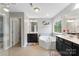 Bright bathroom with dual sink vanity, soaking tub, and a window providing natural light at 15416 Oleander Dr, Charlotte, NC 28278