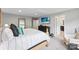 Beautifully staged main bedroom with ensuite bathroom, large TV, and decorative accents at 15416 Oleander Dr, Charlotte, NC 28278