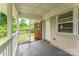 Covered back porch featuring painted white brick and access to the large backyard at 1631 Vancouver Dr, Charlotte, NC 28213
