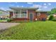An expansive, grassy backyard with a cozy covered porch on a brick home at 1631 Vancouver Dr, Charlotte, NC 28213
