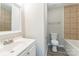 Cozy bathroom featuring a single sink vanity, toilet, and a tub with tiled walls at 1631 Vancouver Dr, Charlotte, NC 28213
