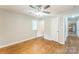This bedroom has hardwood floors, two windows and a doorway leading into the kitchen at 1631 Vancouver Dr, Charlotte, NC 28213