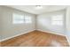 A well-lit room with hardwood floors and two windows provides an airy space at 1631 Vancouver Dr, Charlotte, NC 28213