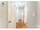 Clean hallway with hardwood floors and neutral paint, connecting various rooms with easy access and flow at 1631 Vancouver Dr, Charlotte, NC 28213