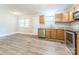 Bright kitchen area with stainless steel dishwasher, granite counters, and vinyl flooring at 1631 Vancouver Dr, Charlotte, NC 28213