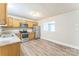 Bright kitchen featuring stainless steel appliances, granite countertops, and modern vinyl plank flooring at 1631 Vancouver Dr, Charlotte, NC 28213