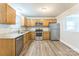 Modern kitchen featuring stainless steel appliances, wood cabinets, and granite countertops at 1631 Vancouver Dr, Charlotte, NC 28213