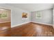 Bright living space with hardwood floors and view into kitchen, promoting an open and connected living experience at 1631 Vancouver Dr, Charlotte, NC 28213