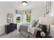 Cozy bedroom with a large window view, featuring neutral decor, modern lighting, and a gray dresser at 1940 Westerhill Dr, Fort Mill, SC 29708