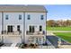 Modern townhome boasts white siding, private balconies, and a convenient attached garage for easy living at 1940 Westerhill Dr, Fort Mill, SC 29708