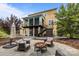 Back exterior featuring a covered deck, patio, firepit, and landscaped yard at 2009 Waterbury Ln, Waxhaw, NC 28173