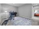 Spacious basement room with an elliptical, a printer and a blue pattern rug, creating a multi-functional area at 2009 Waterbury Ln, Waxhaw, NC 28173