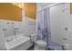 Modern bathroom with white tiling, a stylish sink, and a shower with a patterned curtain at 2009 Waterbury Ln, Waxhaw, NC 28173