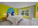 Bright bedroom with lime green walls, a decorative headboard, a white bedspread, and a light-filled window at 2009 Waterbury Ln, Waxhaw, NC 28173