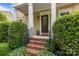Inviting front entrance with brick steps, black railing, and a stylish brown door at 2009 Waterbury Ln, Waxhaw, NC 28173