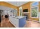 Open-concept kitchen featuring an island with marble countertop, a fireplace, and modern pendant lighting at 2009 Waterbury Ln, Waxhaw, NC 28173