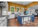 Modern kitchen with island seating, stainless appliances, white cabinets, and stylish countertops at 2009 Waterbury Ln, Waxhaw, NC 28173