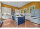 Bright eat-in kitchen with an island, stainless steel appliances, ample cabinet space, and hardwood floors at 2009 Waterbury Ln, Waxhaw, NC 28173