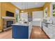 Stylish kitchen featuring a marble island, stone fireplace, stainless steel appliances, and tiled backsplash at 2009 Waterbury Ln, Waxhaw, NC 28173