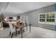 Open concept living and dining area featuring a dining table and living area in the background at 2009 Waterbury Ln, Waxhaw, NC 28173