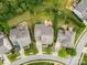 Aerial view of homes showcasing well-manicured lawns, driveways, and mature trees at 2010 Brightflower Ln, York, SC 29745